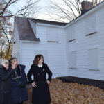 Town Supervisor Judi Bosworth, Marianna Wohlgemuth and Town Councilwoman Lee Seeman examine recently finished siding work on the Schumacher House.