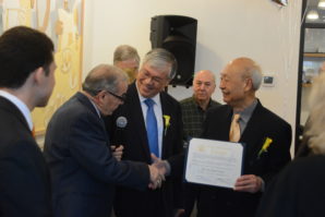 Ren Wen Noodle Factory founder and chairman Ching Sun Wong holds a citation as President Stanley Kwong goes to shake Assemblyman Tony D'Urso's hand. (Photo by Janelle Clausen)
