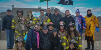Erin Lipinsky, flanked by supporters and members of the Alert Fire Company, came down to Tobay Beach to be "freezin' for a reason." (Photo by Janelle Clausen)