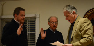 Russell Gardens Mayor Steve Kirschner, right, swears Trustees Matthew Ellis and David Miller into another term. (Photo by Janelle Clausen)