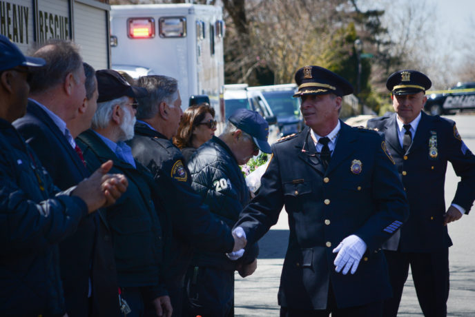 Outgoing Police Chief John Garbedian shakes hands with first responders at a farewell ceremony, with Police Chief Rick Moreno close behind. (Photo by Janelle Clausen)