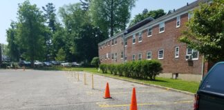24 parking spots in the southern parking lot of Millbrook Court, which is home to 119 apartment units, remain closed off from residential use. This follows a May 1 meeting where it was hinted it could be re-opened within a few days. (Photo by Janelle Clausen)