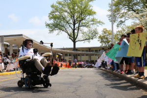 Fourth and fifth-grade students hold handmade signs and cheer on Ride for Life participants. (Photo courtesy of the Great Neck Public Schools)