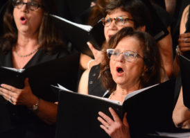 Ann Hirsh, one of the choir's founders, and a host of other singers hit a high note. (Photo by Janelle Clausen)