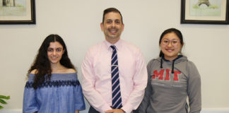 North High Principal Daniel Holtzman congratulates Courtney Hakimian and Megan Xu on being National Merit Scholars. (Photo courtesy of the Great Neck Public Schools)