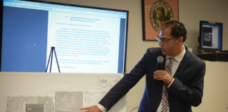 Michael De Giglio, an associate with Cameron Engineering, reviews the early site plan for a proposed Mashadi Jewish Community Center. (Photo by Janelle Clausen)