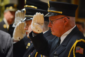 First responders salute Ray Plakstis. (Photo by Janelle Clausen)