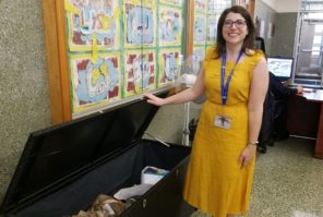 Social worker Julie Goldin shows the donation center in the Saddle Rock Elementary School main lobby. (Photo by Janelle Clausen)