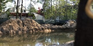 A property in the Village of Great Neck has filled with water over a course of months, in effect creating a pool where a home would otherwise be. (Photo provided to the Great Neck News)