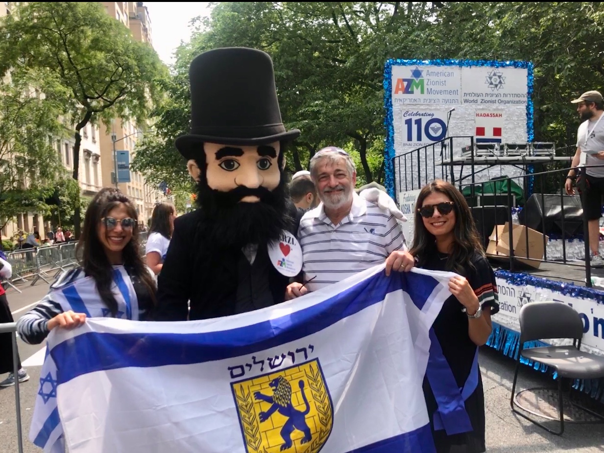 “Theodor Herzl,” Father of the modern-day State of Israel, with Great Neck Estates supporters Lia Brody, Dr. Pauly Brody and Dana Brody, Esq. who proudly display the flag of Jerusalem, or Yerushalayim, at the Israel Day Parade, as part of the contingent on the World Zionist Organization float. (Photo courtesy of Dr. Paul Brody)