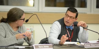 North Shore Superintendent of Schools Peter Giarrizzo speaks with Sara Jones, the school board president, during a business meeting about the impact of a possible settlement between LIPA and Nassau County. (Photo by Janelle Clausen)